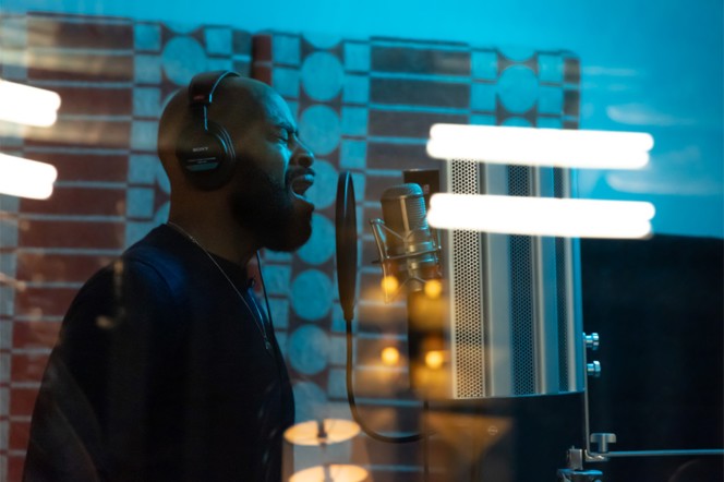 A singer in the vocal booth at Floki.